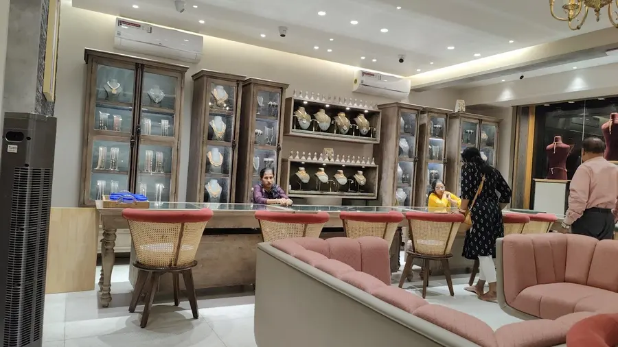 The ground floor counter with cane backed chairs and glass cabinets.
