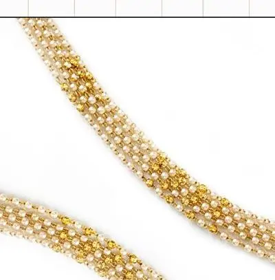 Two strands of pearl and gold moti mala on a white ground.